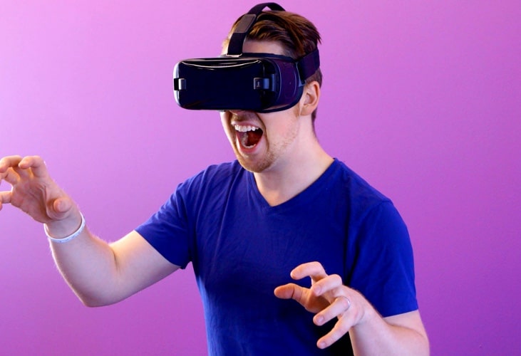 Image of a man playing with a VR device